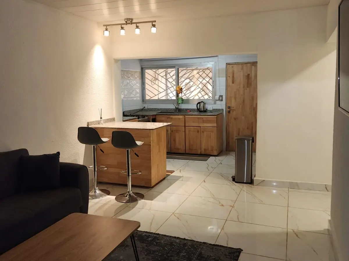 Open-plan living room and kitchen of the Sahkahn two-bedroom rental apartment in Monrovia